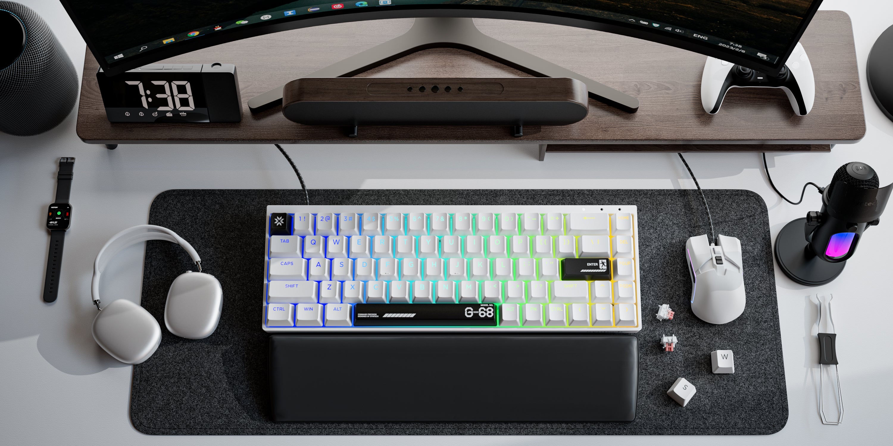 Desk setup with Syntech Chronos keyboard, mouse, headphones, and computer monitor.